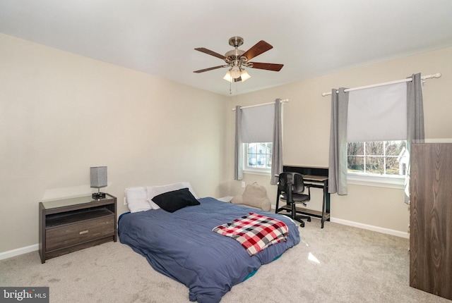 carpeted bedroom with multiple windows and baseboards