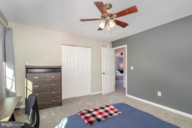 carpeted bedroom with visible vents, baseboards, a closet, and ceiling fan