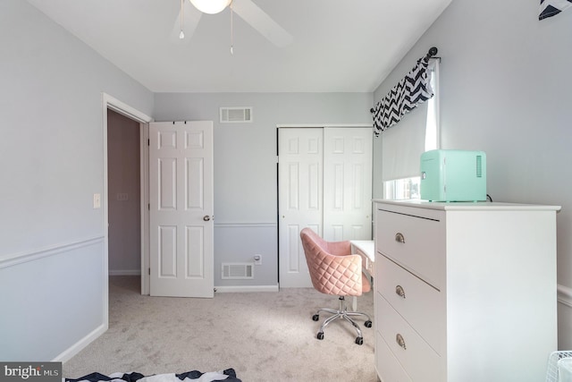 unfurnished office with visible vents, baseboards, carpet, and a ceiling fan