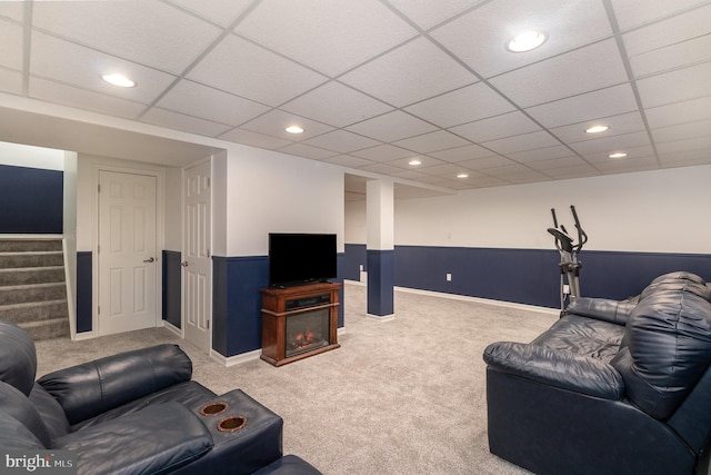 carpeted living room with wainscoting, recessed lighting, stairs, and a paneled ceiling