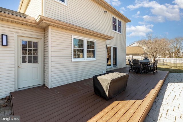 wooden terrace featuring outdoor dining space and fence