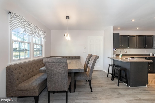 dining room with light wood finished floors and recessed lighting