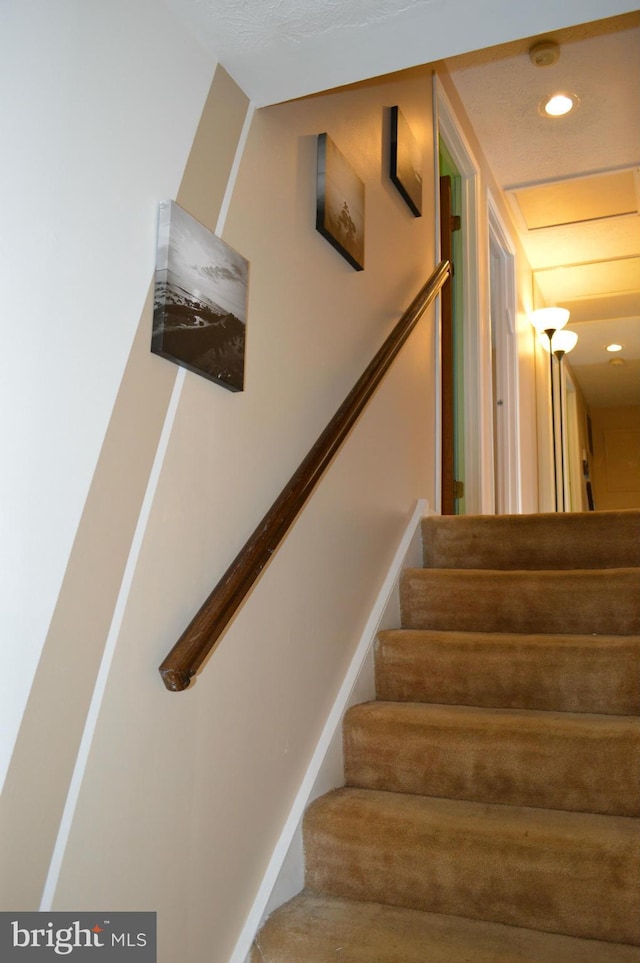 staircase featuring recessed lighting