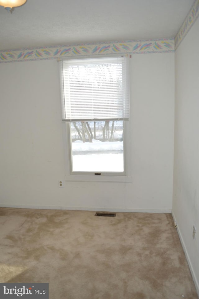 carpeted spare room with visible vents