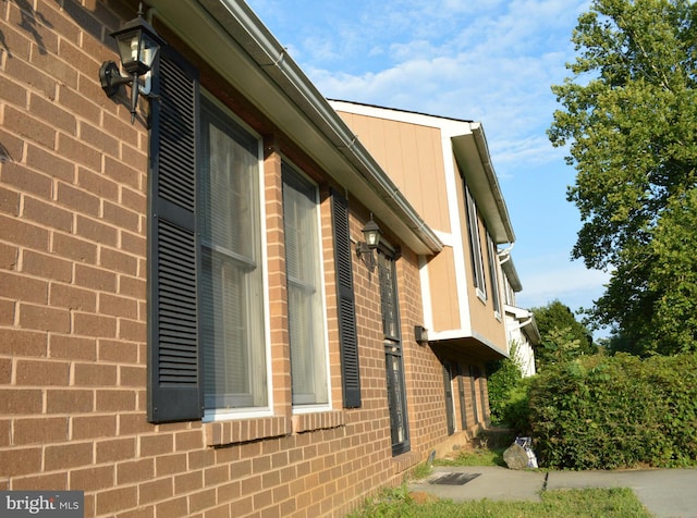 view of property exterior with brick siding