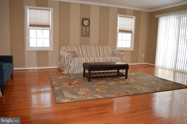 interior space featuring a healthy amount of sunlight, light wood finished floors, baseboards, and crown molding