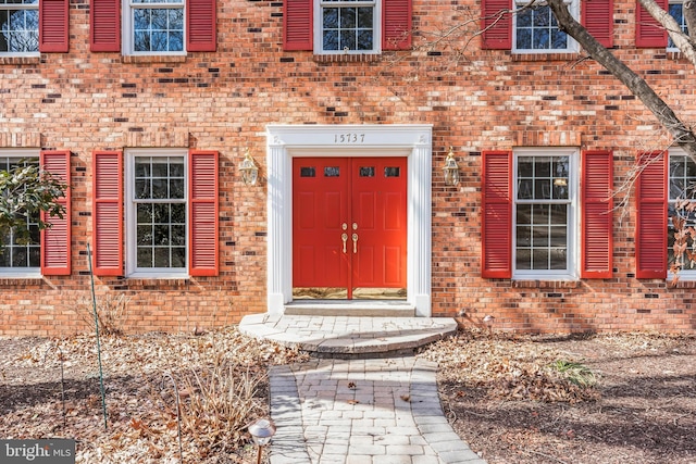 property entrance featuring brick siding