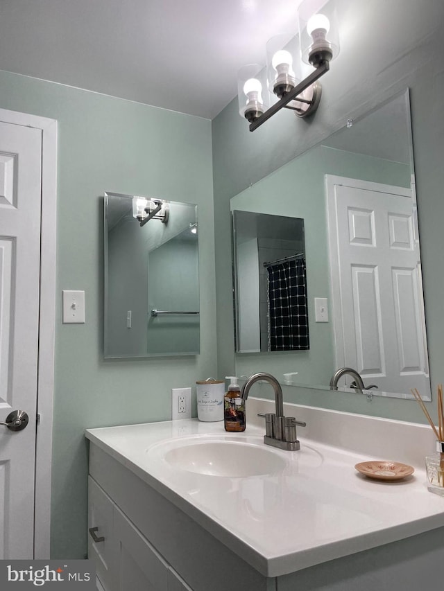 full bath featuring a chandelier and vanity