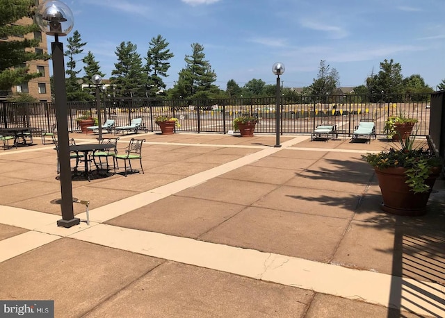 view of home's community featuring fence