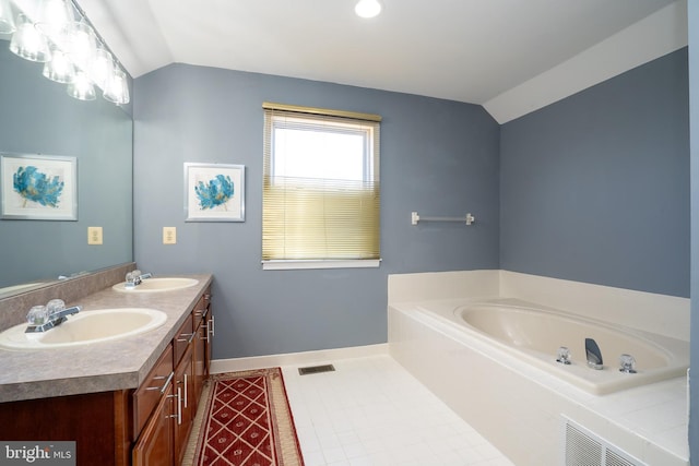 bathroom with lofted ceiling, double vanity, and a sink