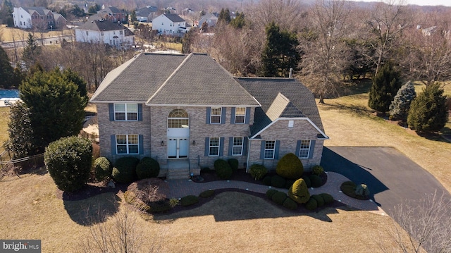 view of front of property featuring driveway and stone siding