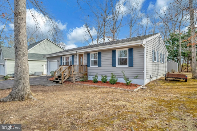 ranch-style house with driveway and an attached garage