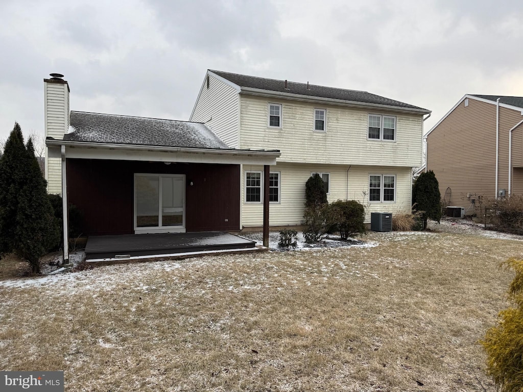 rear view of property with a patio, a chimney, and central air condition unit