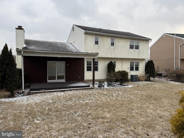 rear view of property with a patio, a chimney, and central air condition unit