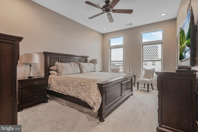 bedroom with ceiling fan, recessed lighting, visible vents, and light colored carpet