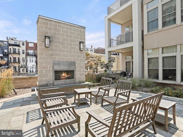 view of patio / terrace with an outdoor brick fireplace