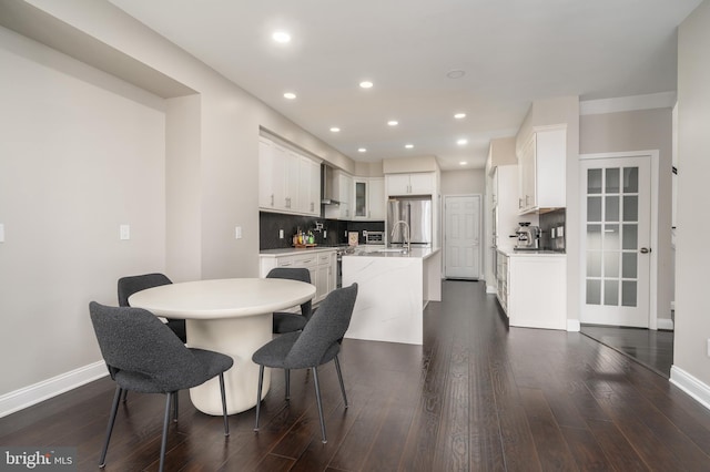 dining area featuring baseboards, dark wood-style flooring, and recessed lighting