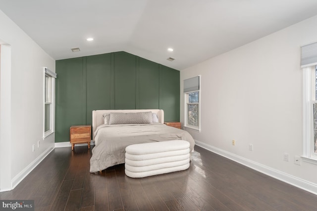 bedroom featuring lofted ceiling, baseboards, visible vents, and dark wood-style flooring