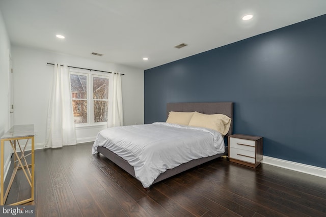 bedroom featuring dark wood-type flooring, visible vents, and baseboards