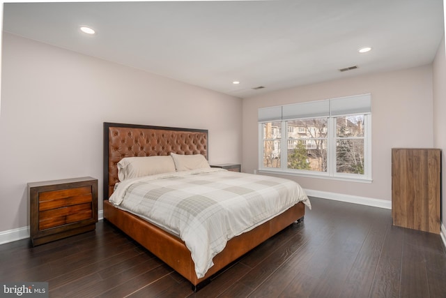 bedroom with baseboards, visible vents, dark wood-type flooring, and recessed lighting