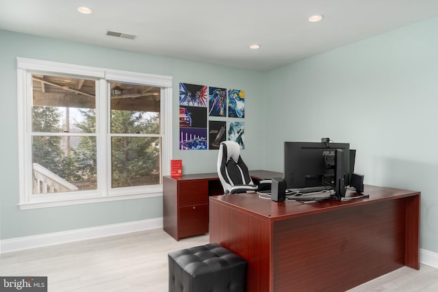 office area with light wood finished floors, baseboards, visible vents, and recessed lighting