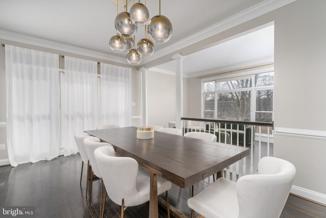 dining area featuring decorative columns, baseboards, dark wood-style floors, ornamental molding, and a notable chandelier