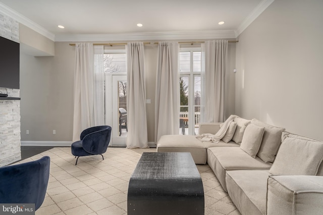 living area with plenty of natural light, crown molding, and baseboards