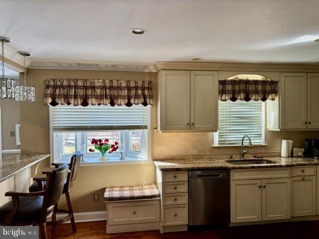 kitchen featuring plenty of natural light, a sink, stainless steel dishwasher, and light stone countertops