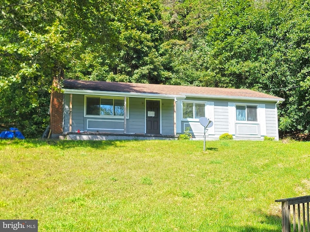 ranch-style house with covered porch and a front lawn