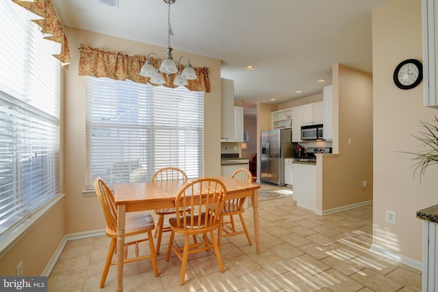 dining area with plenty of natural light, baseboards, a notable chandelier, and recessed lighting