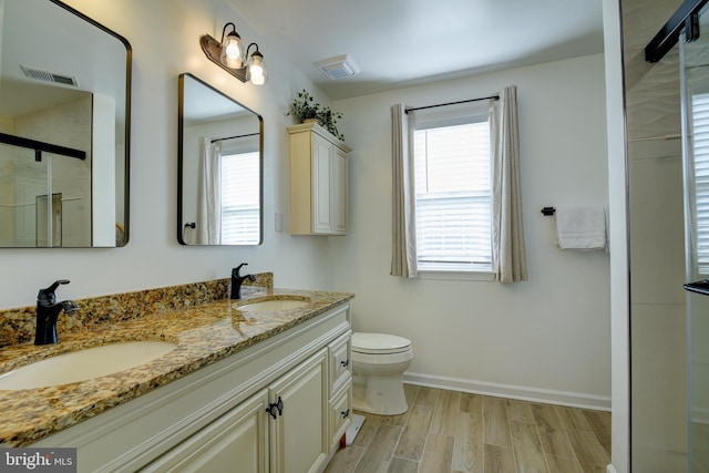 full bathroom featuring a healthy amount of sunlight, visible vents, and a sink