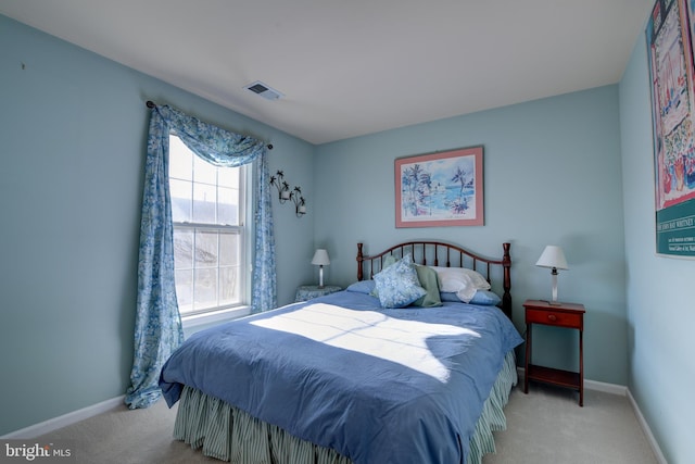 carpeted bedroom featuring visible vents and baseboards