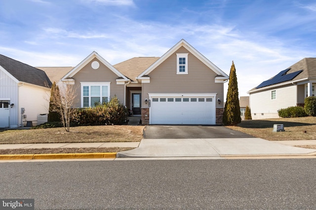 view of front of property featuring stone siding, driveway, an attached garage, and central air condition unit