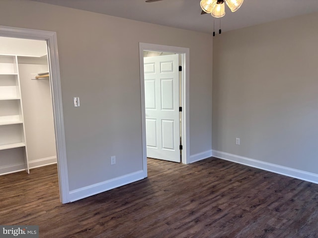 601 Gibbs Rd, Madison, VA 22727 - unfurnished bedroom featuring a closet, a spacious closet, baseboards, and dark wood-type flooring
