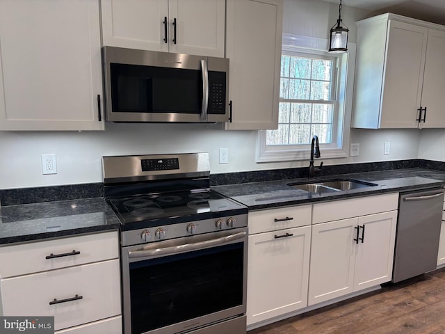 601 Gibbs Rd, Madison, VA 22727 - kitchen with dark wood-type flooring, hanging light fixtures, stainless steel appliances, white cabinetry, and a sink