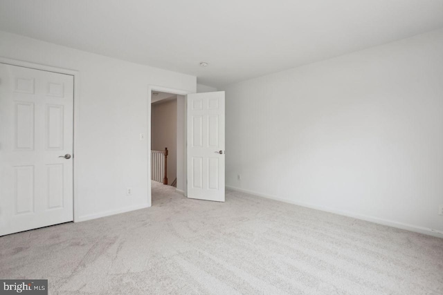 unfurnished bedroom with carpet flooring and baseboards