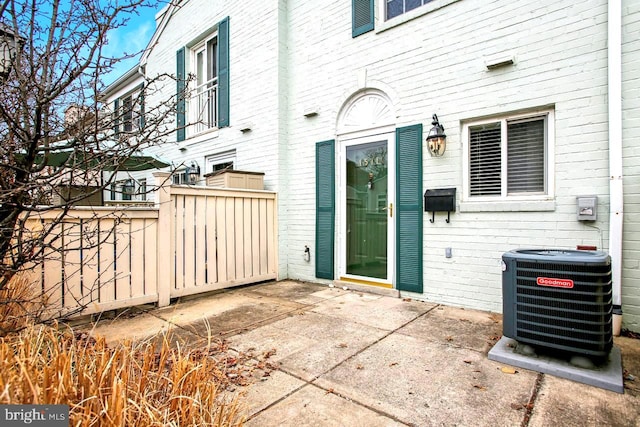 exterior space featuring cooling unit and fence