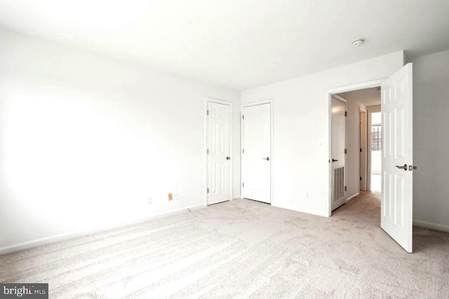 unfurnished bedroom with light colored carpet