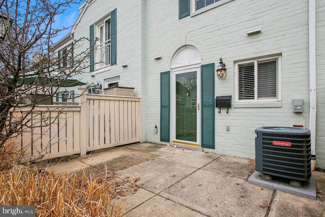 view of patio featuring central AC and fence