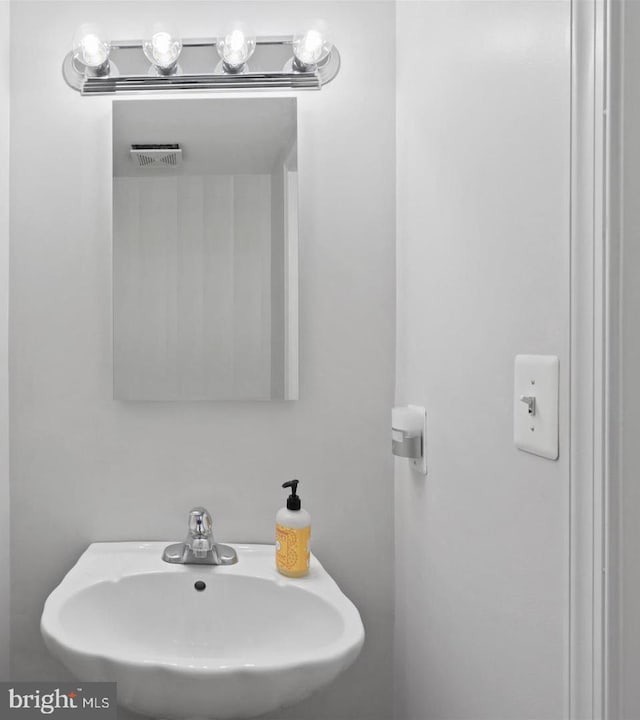 bathroom with a sink and visible vents