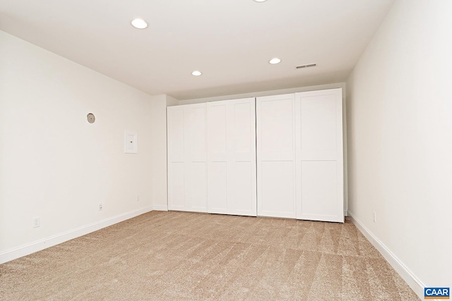 unfurnished bedroom with light carpet, baseboards, visible vents, and recessed lighting