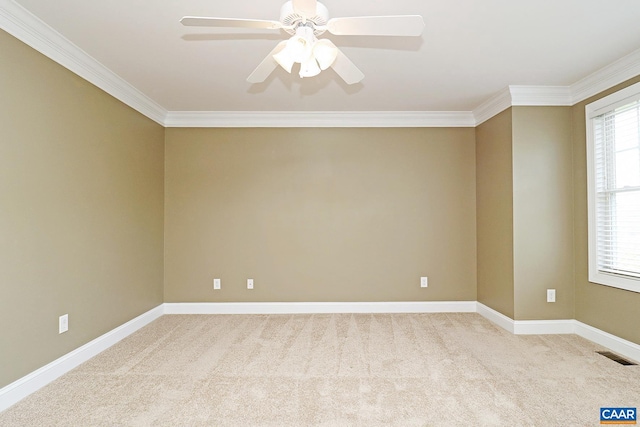 unfurnished room with baseboards, visible vents, ornamental molding, and light colored carpet