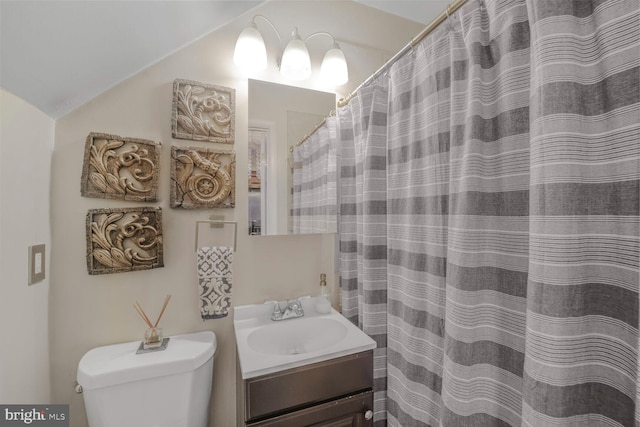 full bath featuring vaulted ceiling, vanity, and toilet