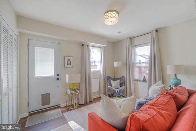 interior space with baseboards and wood finished floors