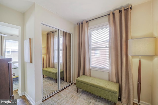 doorway featuring a wealth of natural light, baseboards, and wood finished floors