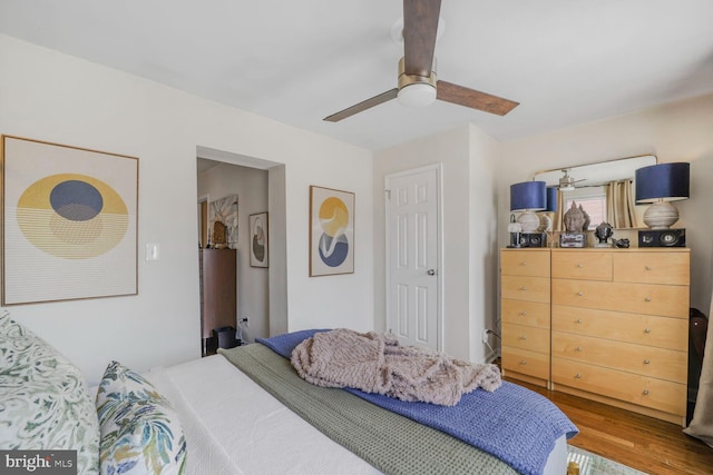 bedroom featuring a ceiling fan and wood finished floors