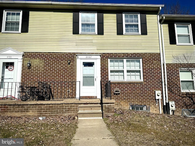 multi unit property featuring entry steps and brick siding