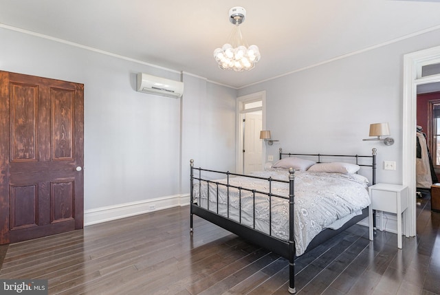 bedroom featuring a notable chandelier, wood finished floors, baseboards, ornamental molding, and a wall mounted air conditioner