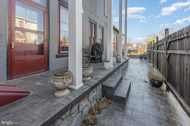 view of patio / terrace featuring fence