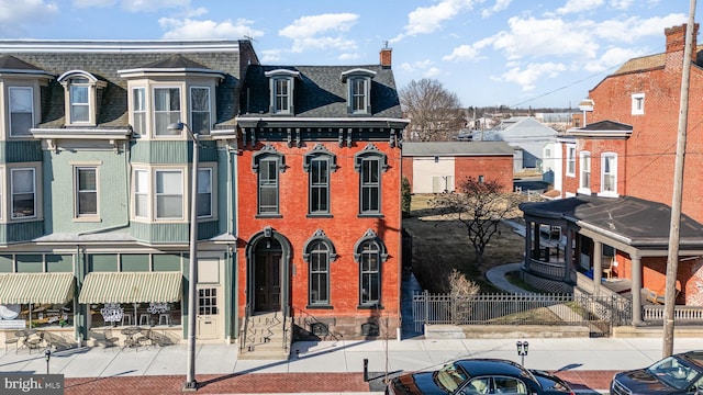 view of building exterior with fence and a residential view